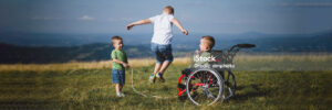 three children play jump rope in empty field