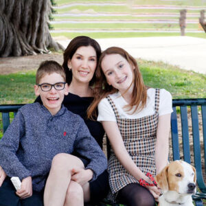 All for Kids Home Health Colorado founder, her children and dog pose for a photo on a park bench