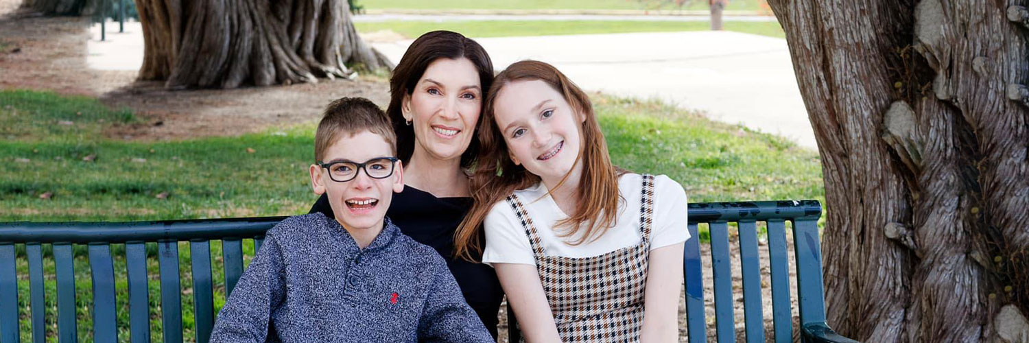 All for Kids Home Health Colorado photo of founder and her two children on park bench