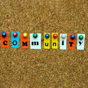 cork board with the word community spelled out with individual letters All for Kids Home Health Colorado